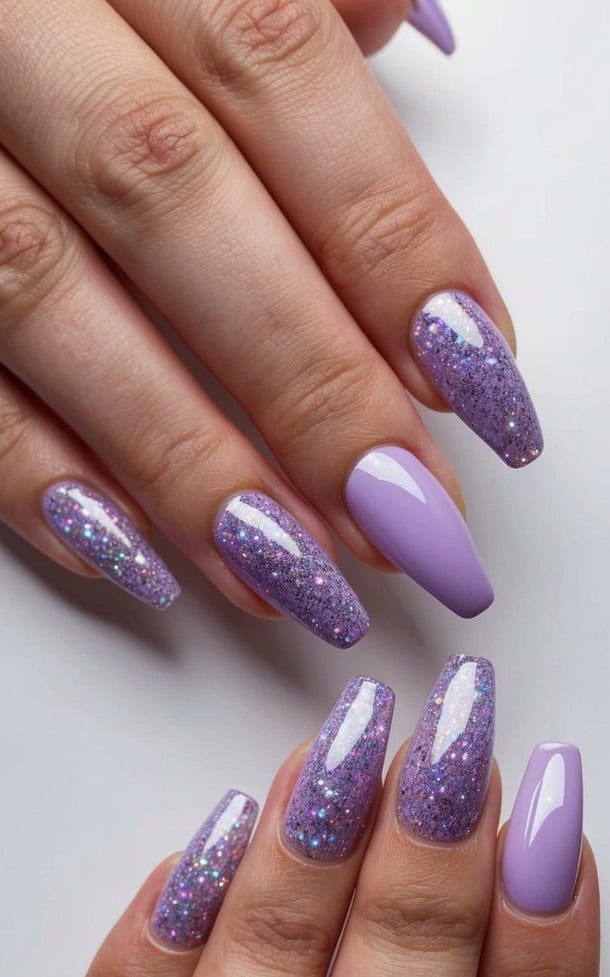 Short glitter nails feature lush lavender hues and luxurious sparkle