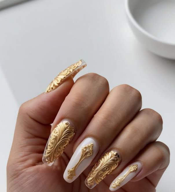 A luxurious display of intricate gold Art Deco-inspired acrylic nail designs arranged on a sleek, modern surface