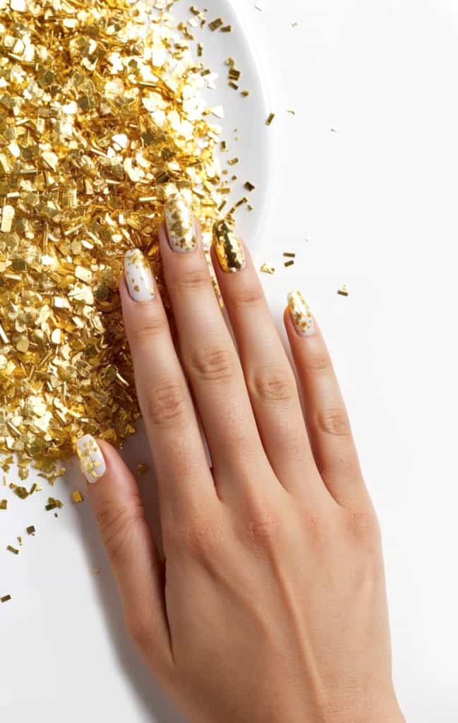 A close-up view of gold confetti nails