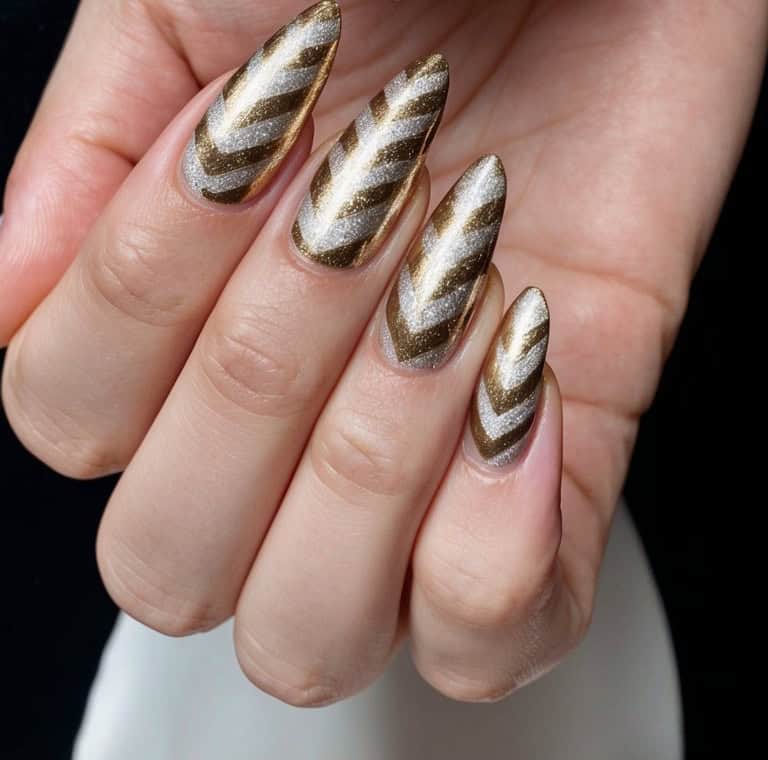 A close-up of metallic gold chevron and silver nail designs on a black background