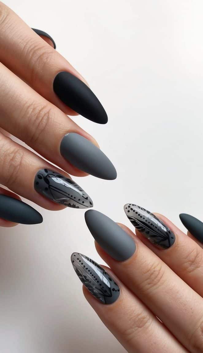 A set of nails painted with a smooth gradient ombre from black to charcoal, showcasing various designs and patterns