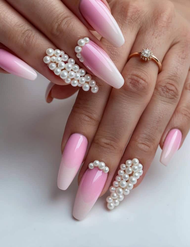 A set of pink ombre nails and accent nails studded with pearls