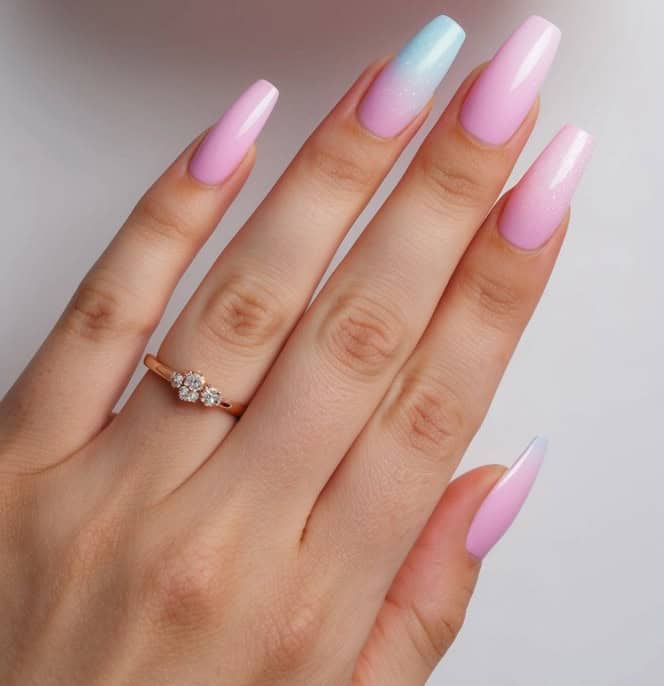 A gradient of soft pink and light blue ombre nail art designs, creating a dreamy and whimsical look