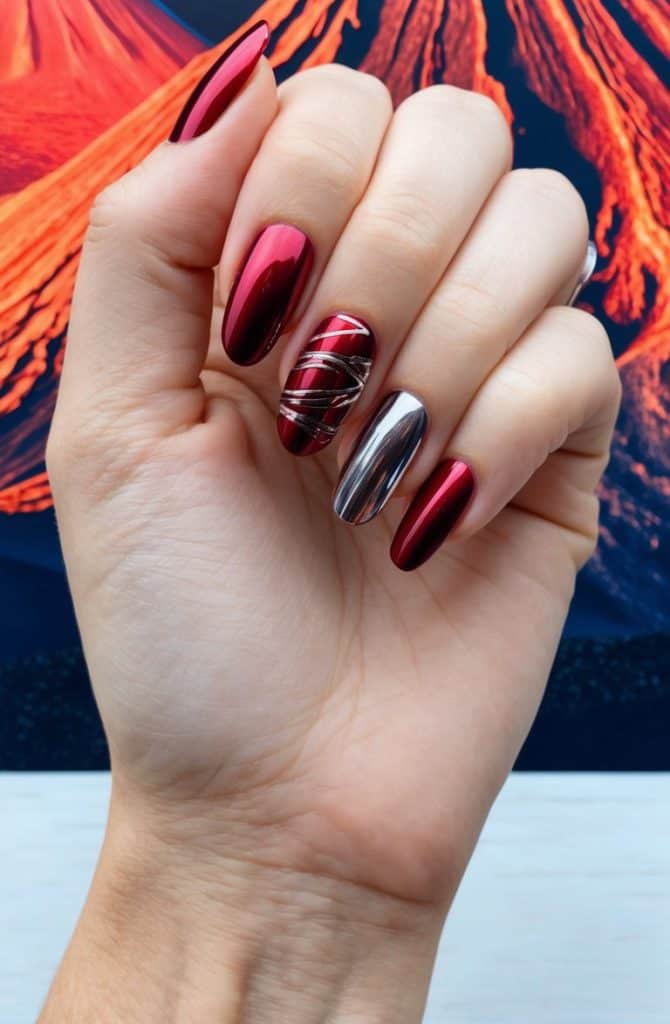 A close-up of red chrome nail art designs
