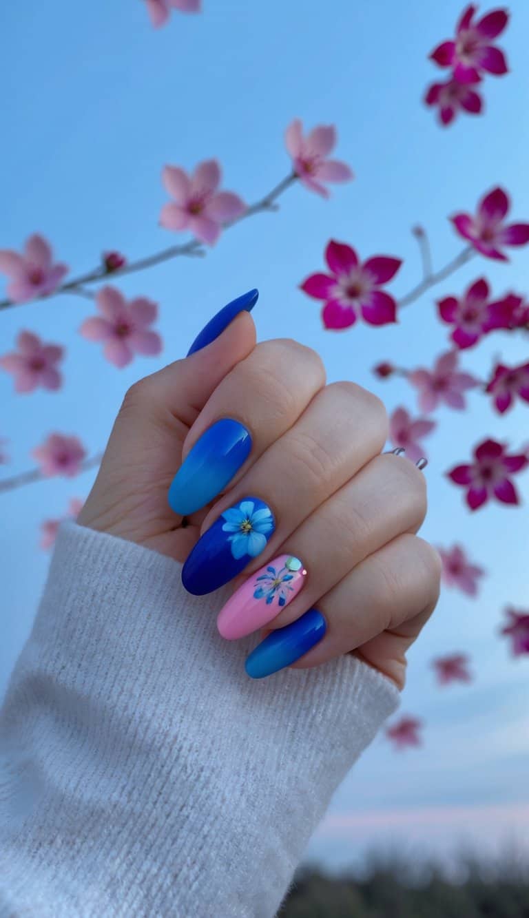 Soft blue fades into deep blue, mirroring the magical transition from day to night, and features blue blooms. Meanwhile, a pink accent nail showcases a light-blue rhinestone and a deep blue flower.