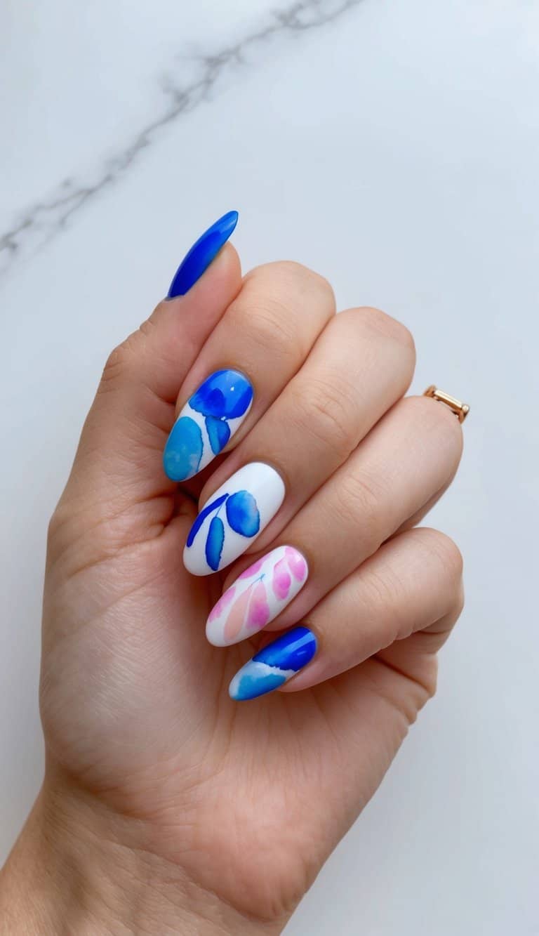 Vibrant blue and pink nail art designs on a clean, white background with delicate watercolor details
