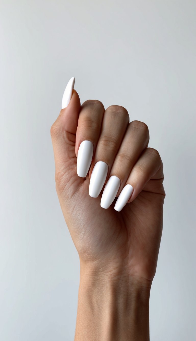 A clean, modern hand with matte white nails on a minimalist background