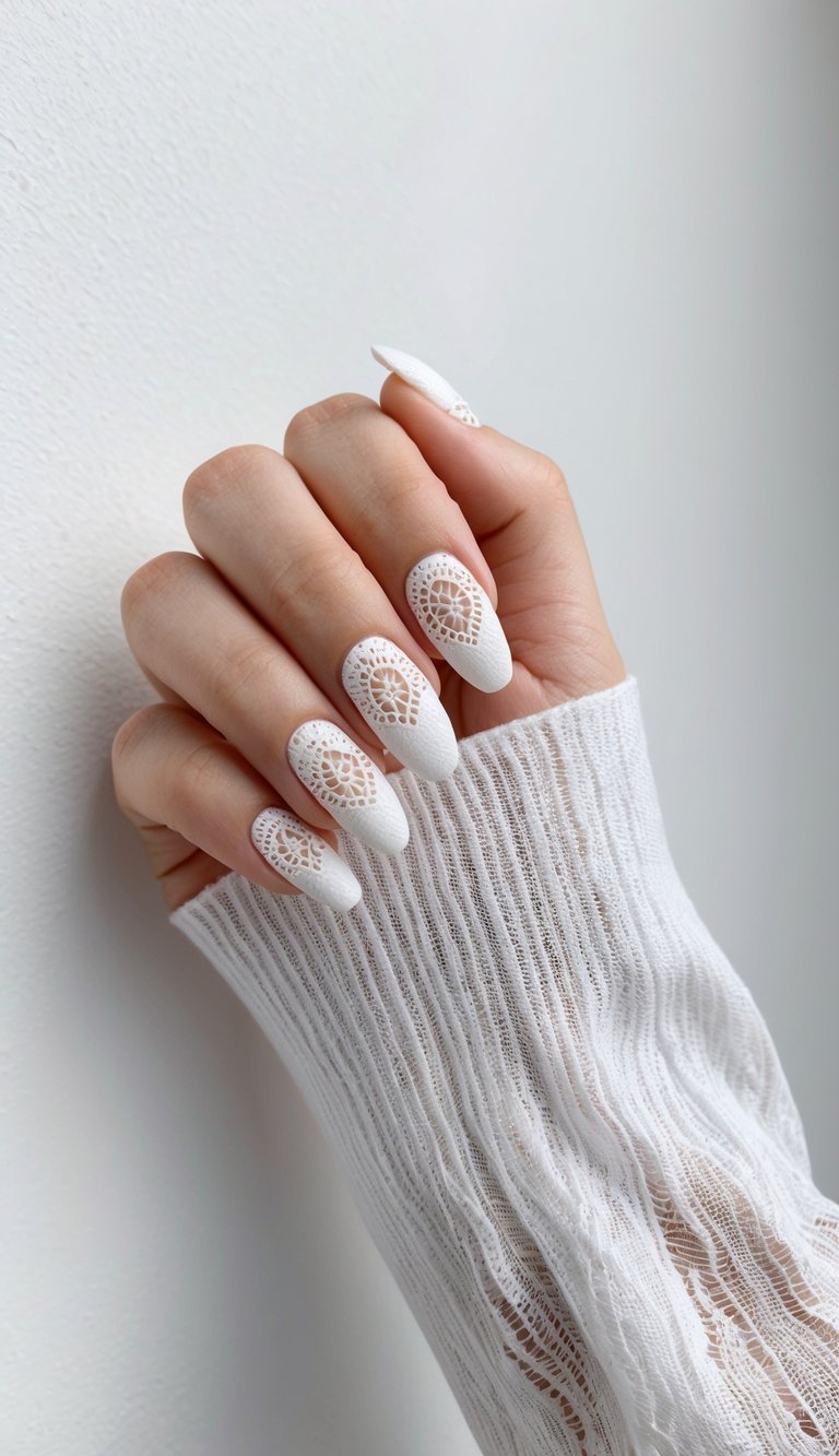 Close-up of romantic matte white nails with crochet-style lace cutout accents.