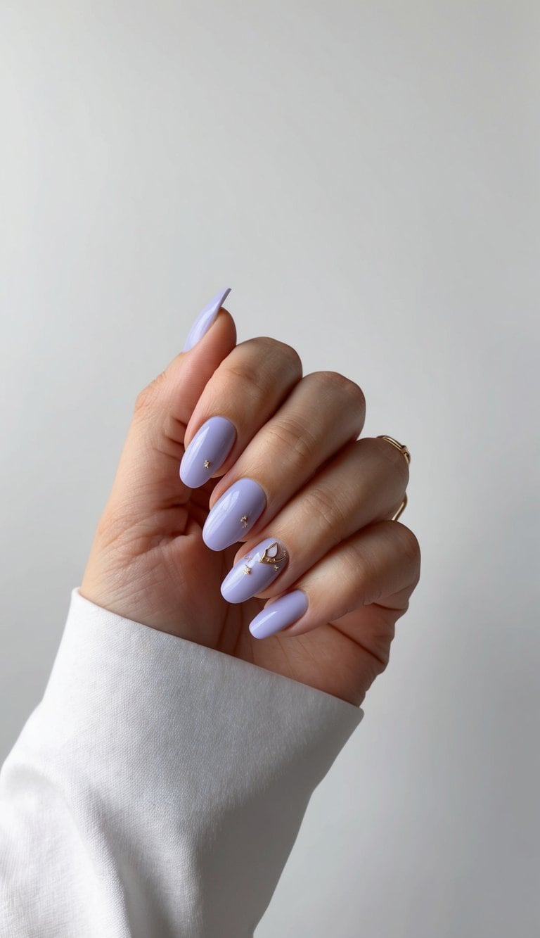 Periwinkle nails with delicate gold accents on a clean, modern background
