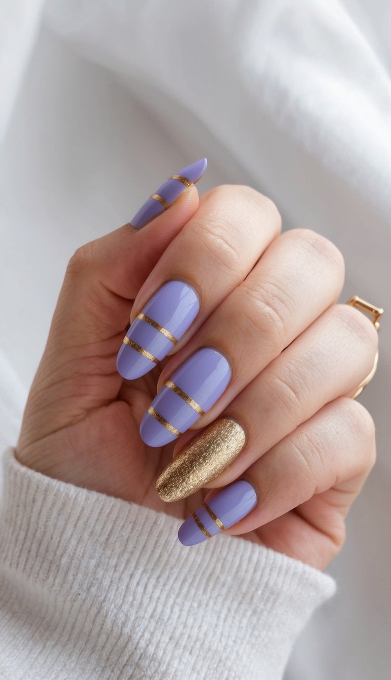 A close-up of periwinkle and gold striped nail art designs on a soft, stylish background