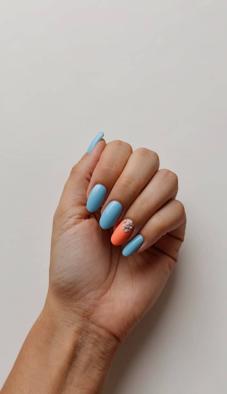 A close-up of periwinkle and coral nail art designs on a clean, neutral background