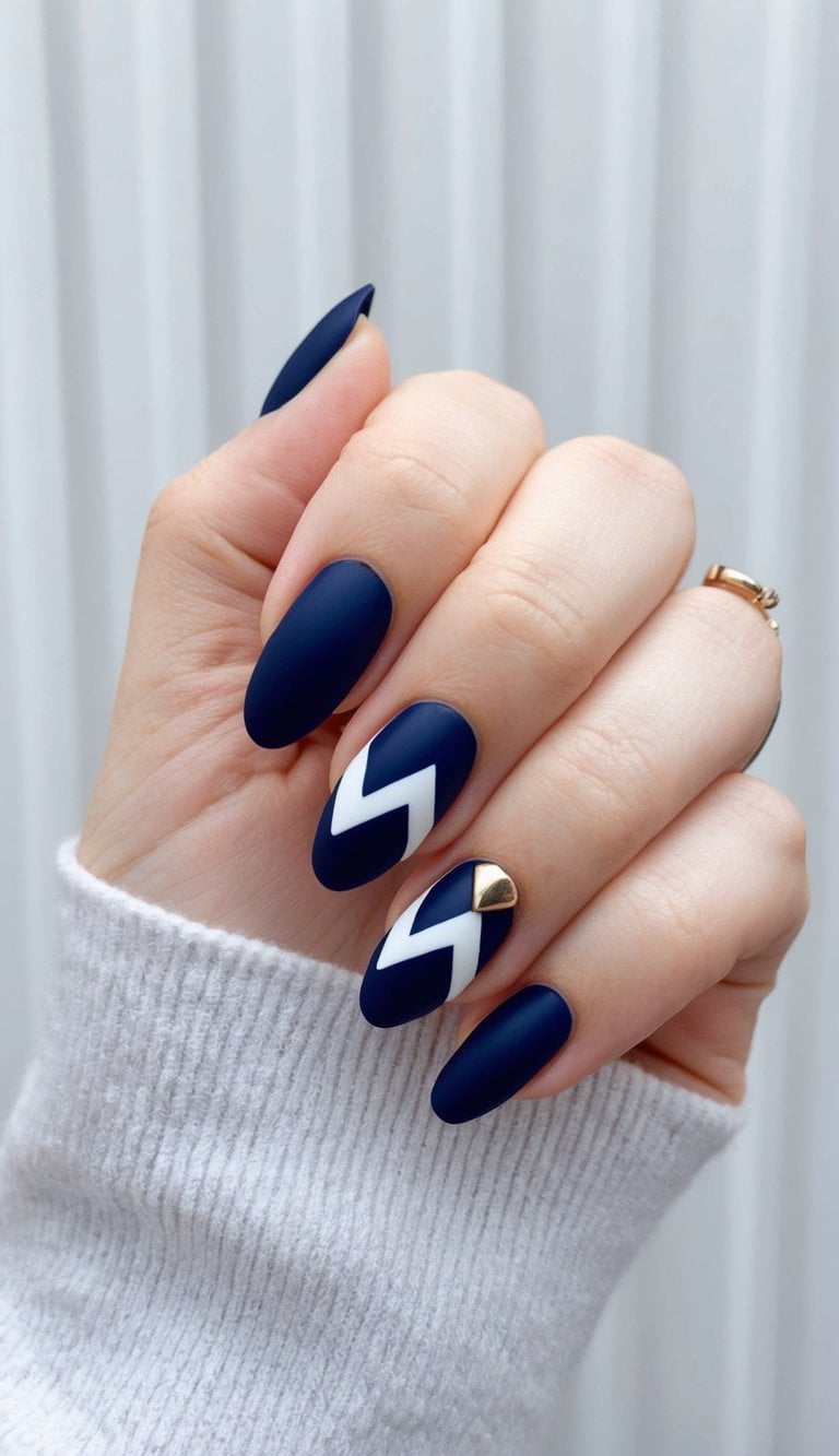 A navy blue nail with a white chevron design, set against a metallic background