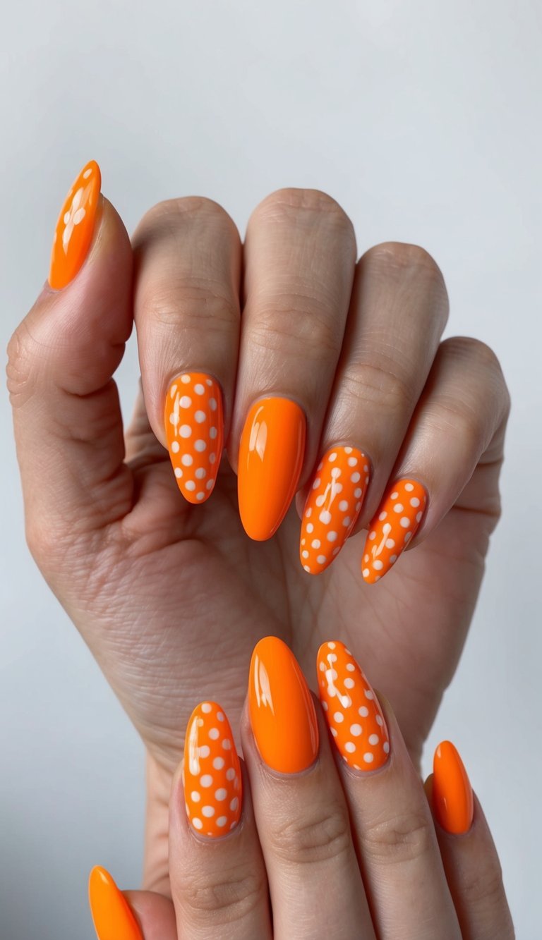 Glossy neon orange nails with alternating white polka dot accents for a playful and eye-catching design.