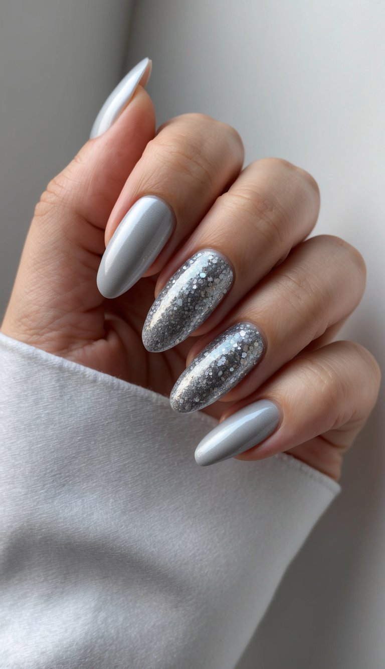 A close-up of sleek silver nails with a gradient of silver glitter, shimmering under soft lighting