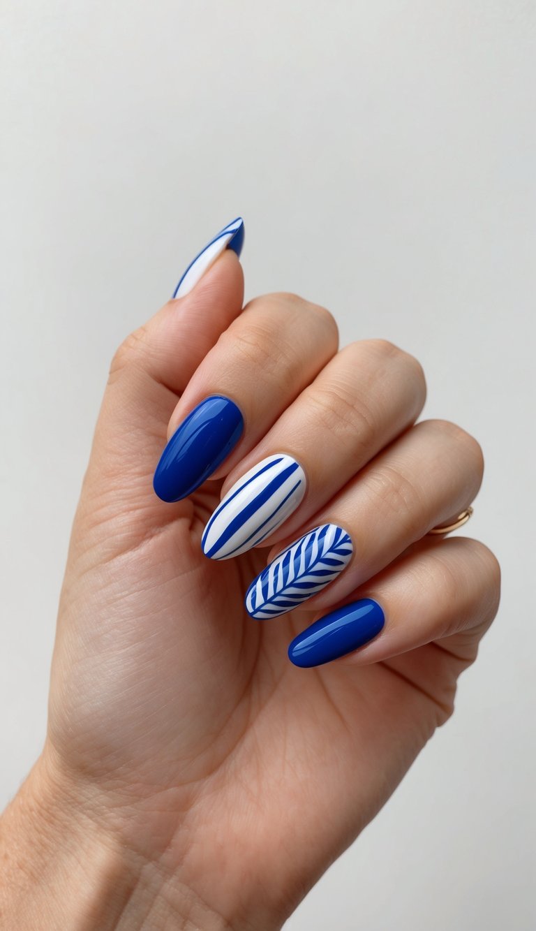 A close-up of blue and white nail art designs on a clean, neutral background