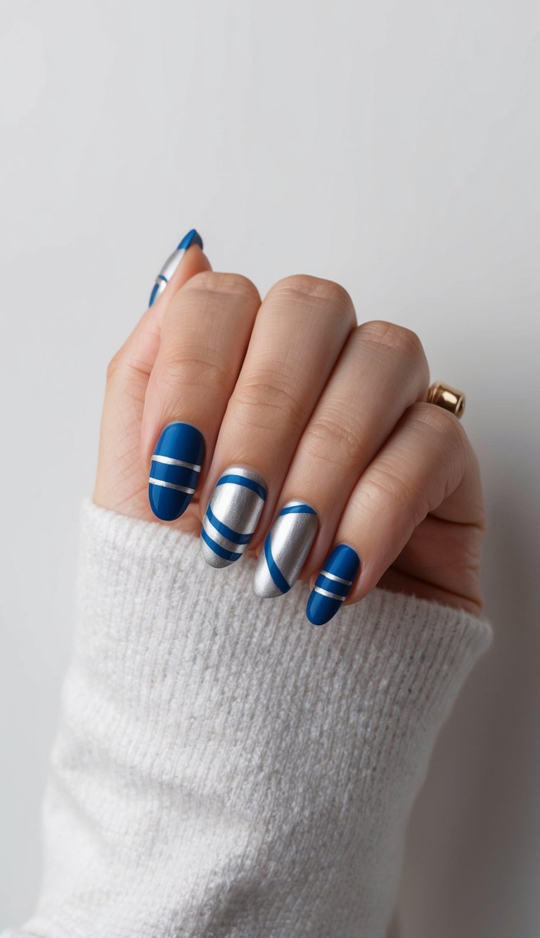 Sharp-lined cobalt and silver nails with matte and metallic contrast, creating a sleek, futuristic nail art statement.