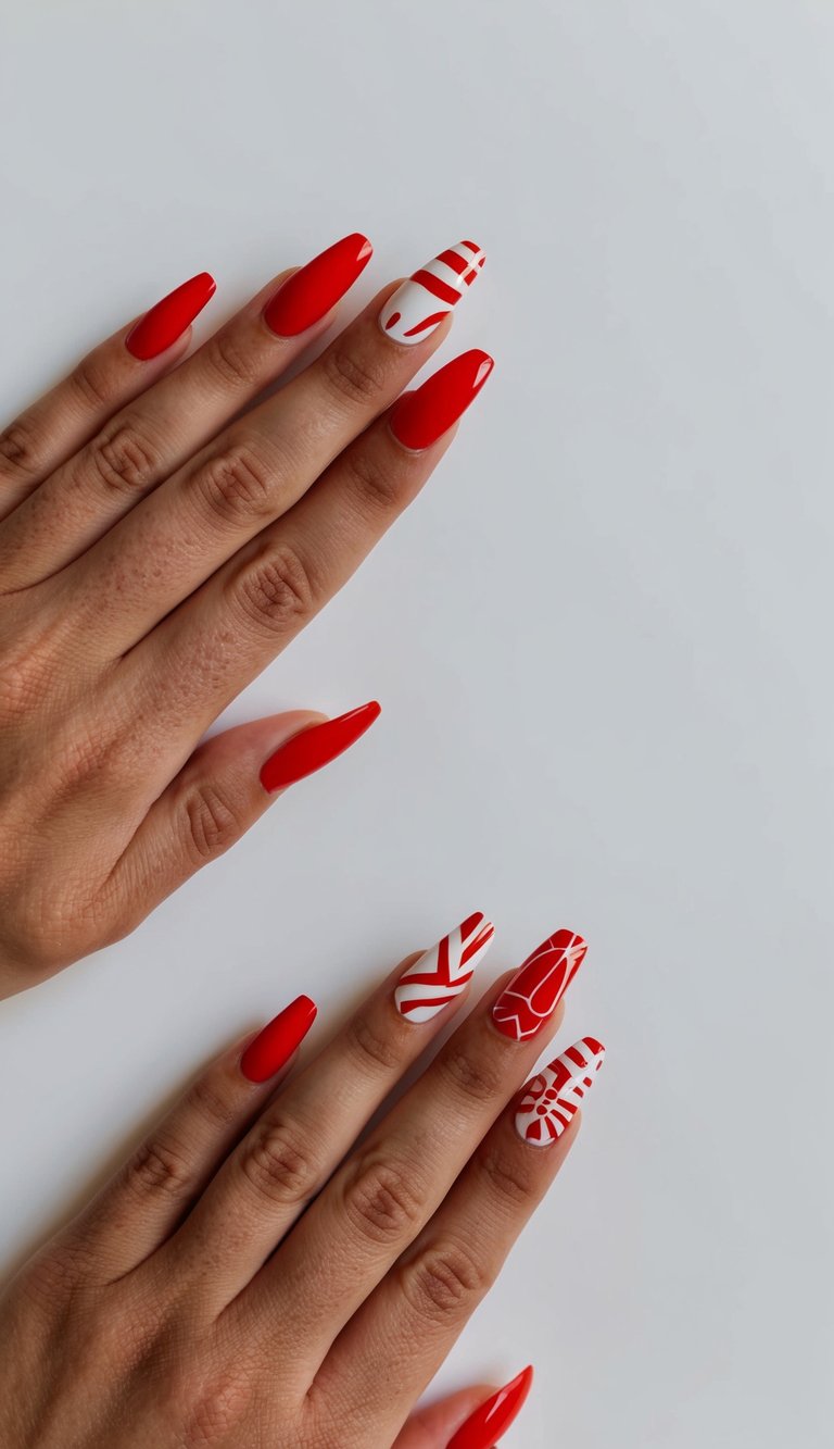 Nails featuring a mix of solid red and abstract red-on-white candy patterns, including stripes, swirls, and peppermint-style bursts.