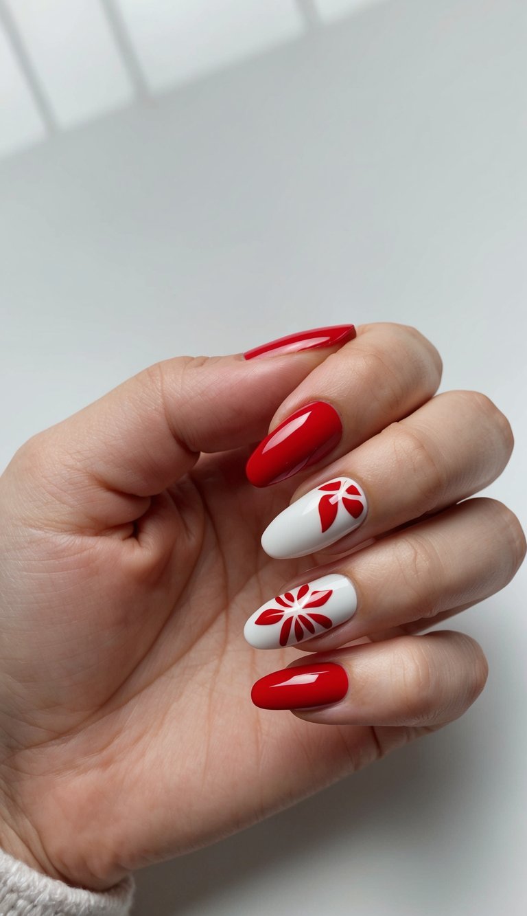 Glossy red nails paired with white nails featuring petal-shaped red floral cutouts for a modern, holiday-inspired design.