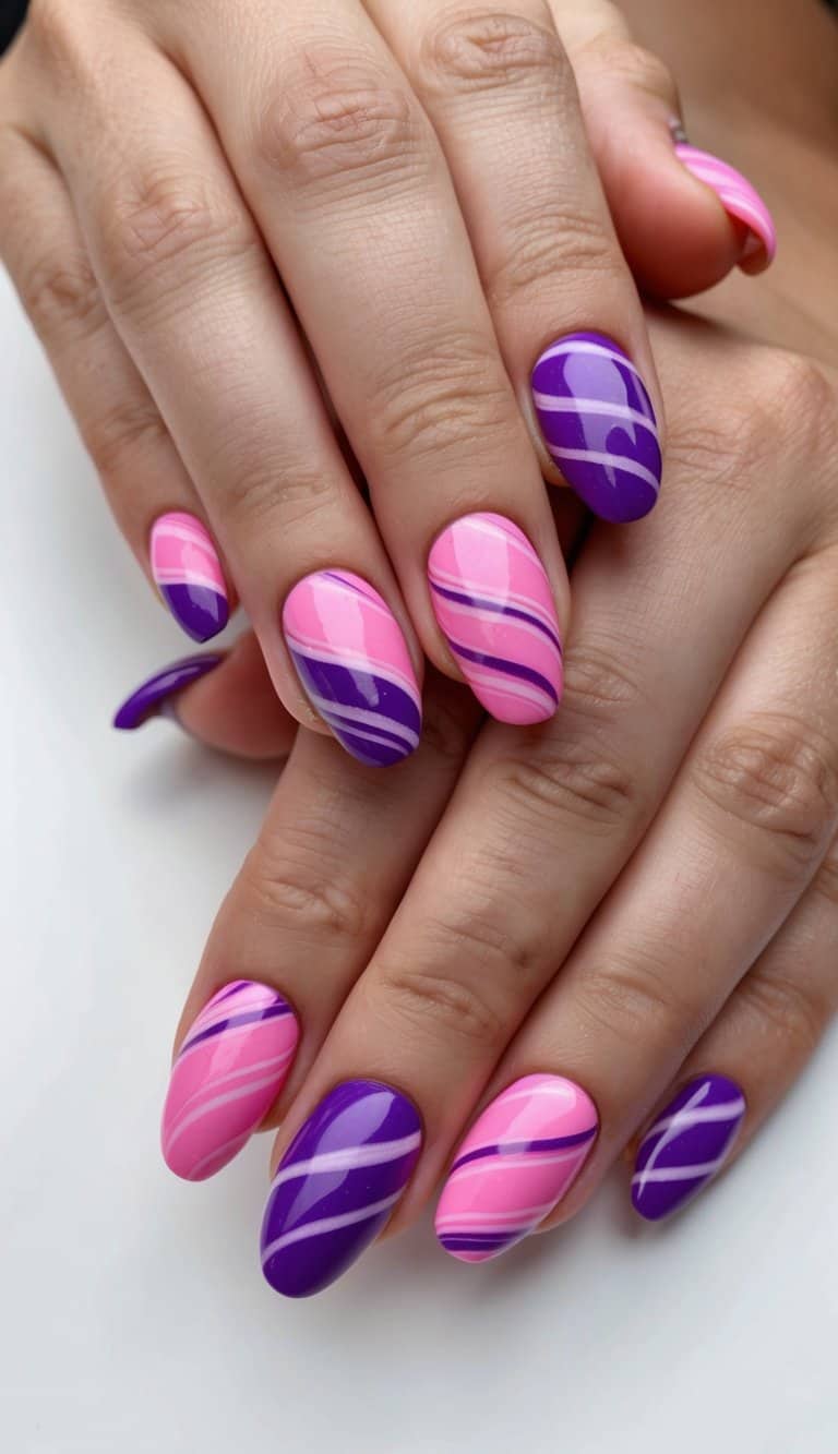 Vibrant pink and purple nails with candy-inspired swirls