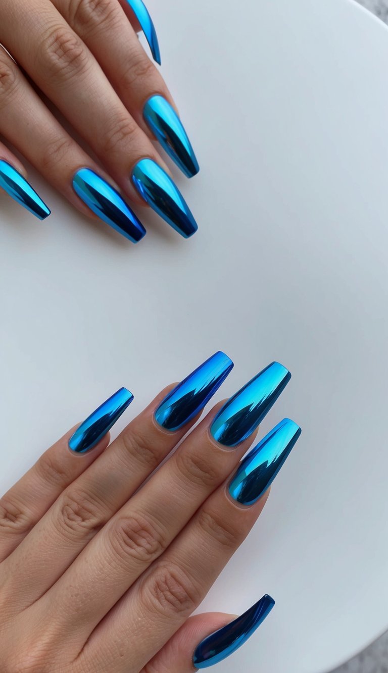 A set of iridescent cobalt chrome nails in various blue chrome designs displayed on a clean, minimalist surface
