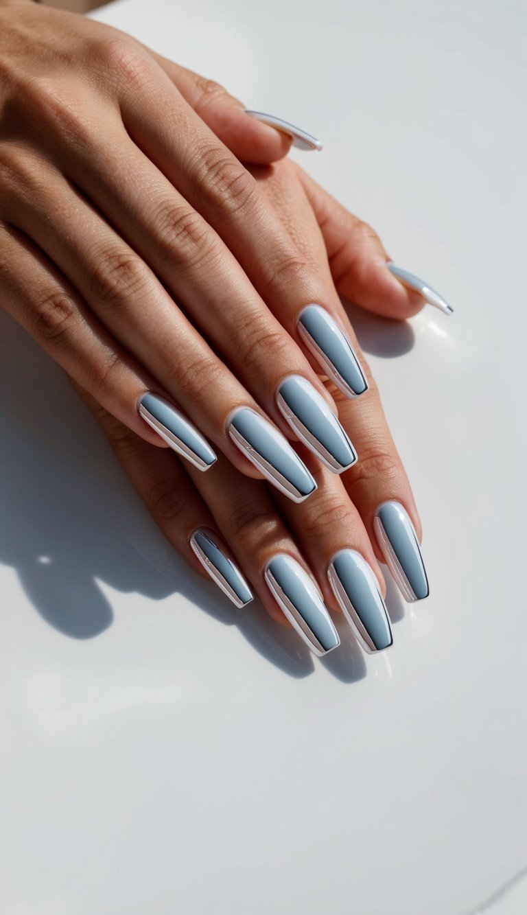 A set of glossy white chrome nails arranged in a sleek and sophisticated pattern on a clean white surface