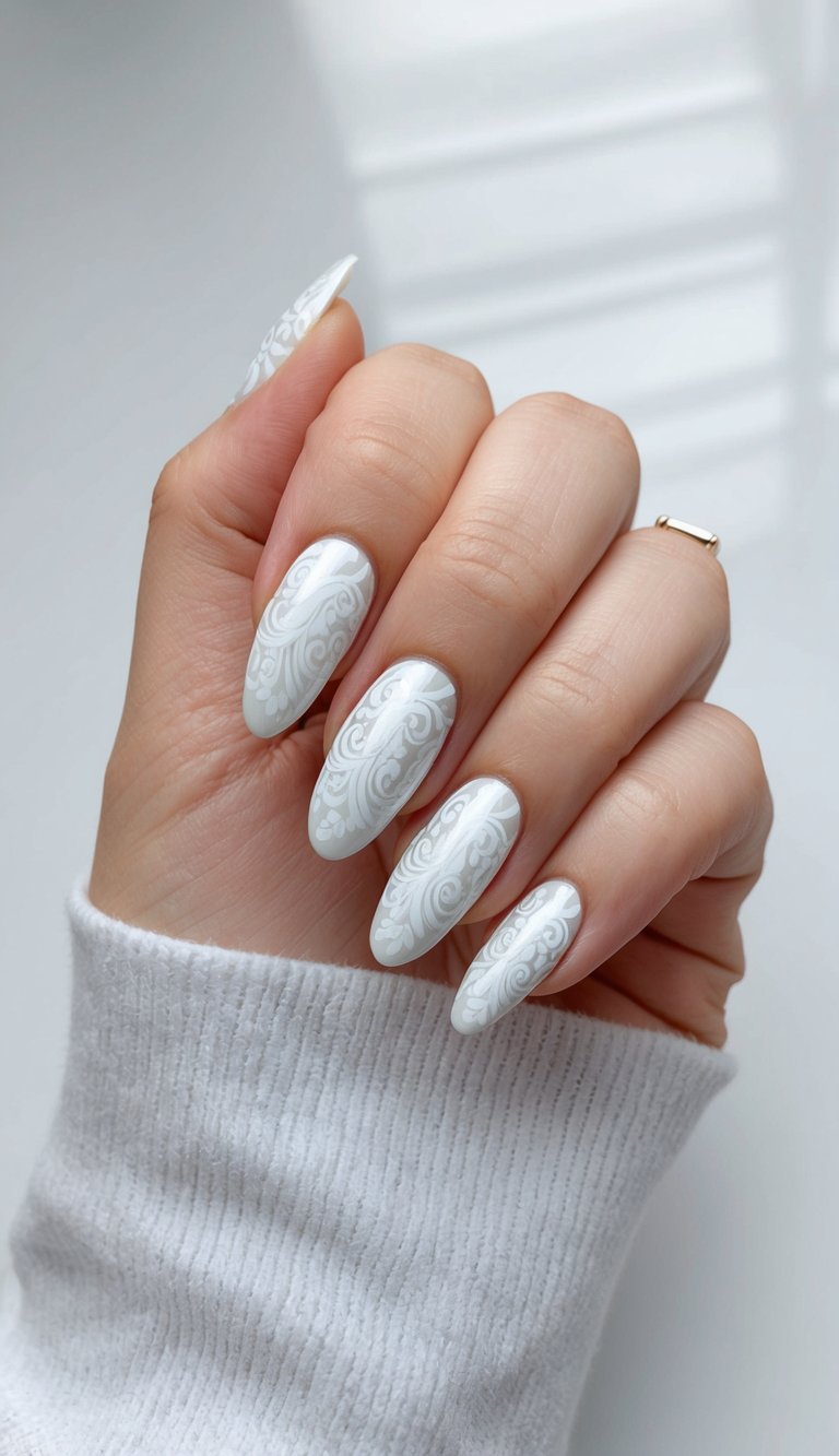 A close-up of white chrome paisley nail art on a sleek, modern background