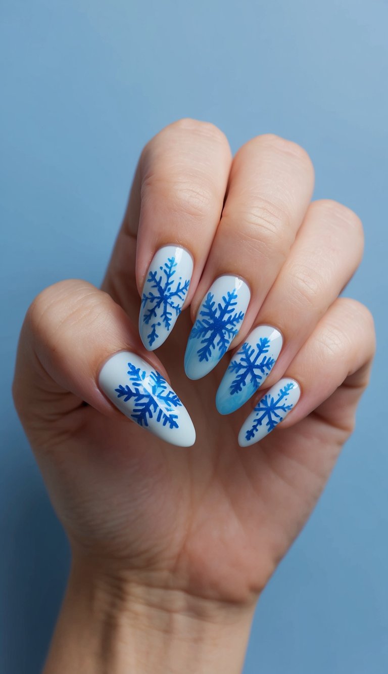 A close-up of 50 ice blue snowflake nail art designs on a matte blue background