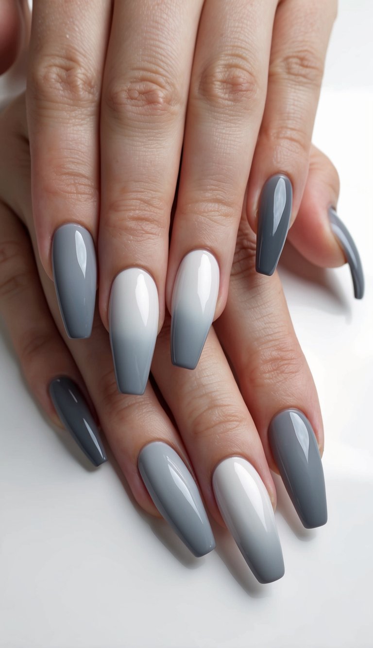 A gradient of elegant gray ombre nail polish, transitioning from light to dark, on a smooth surface