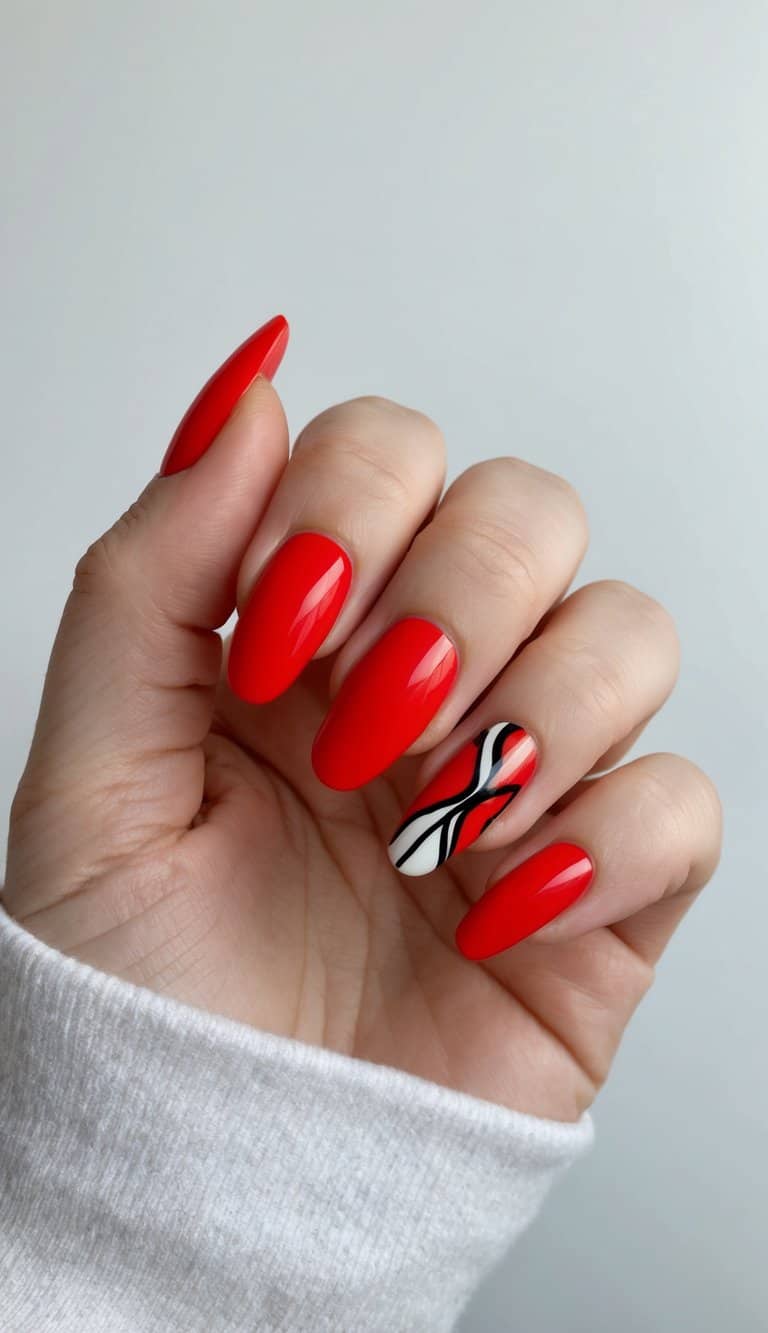 Vibrant red acrylic nails with an abstract art design on one accent nail