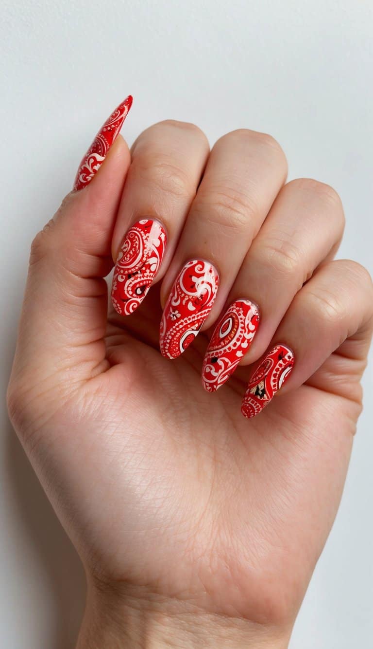 Vibrant red paisley prints on acrylic nails, elegant and eye-catching