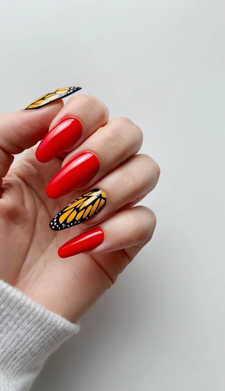 Vibrant red acrylic nails adorned with intricate monarch wing designs on a clean, neutral background