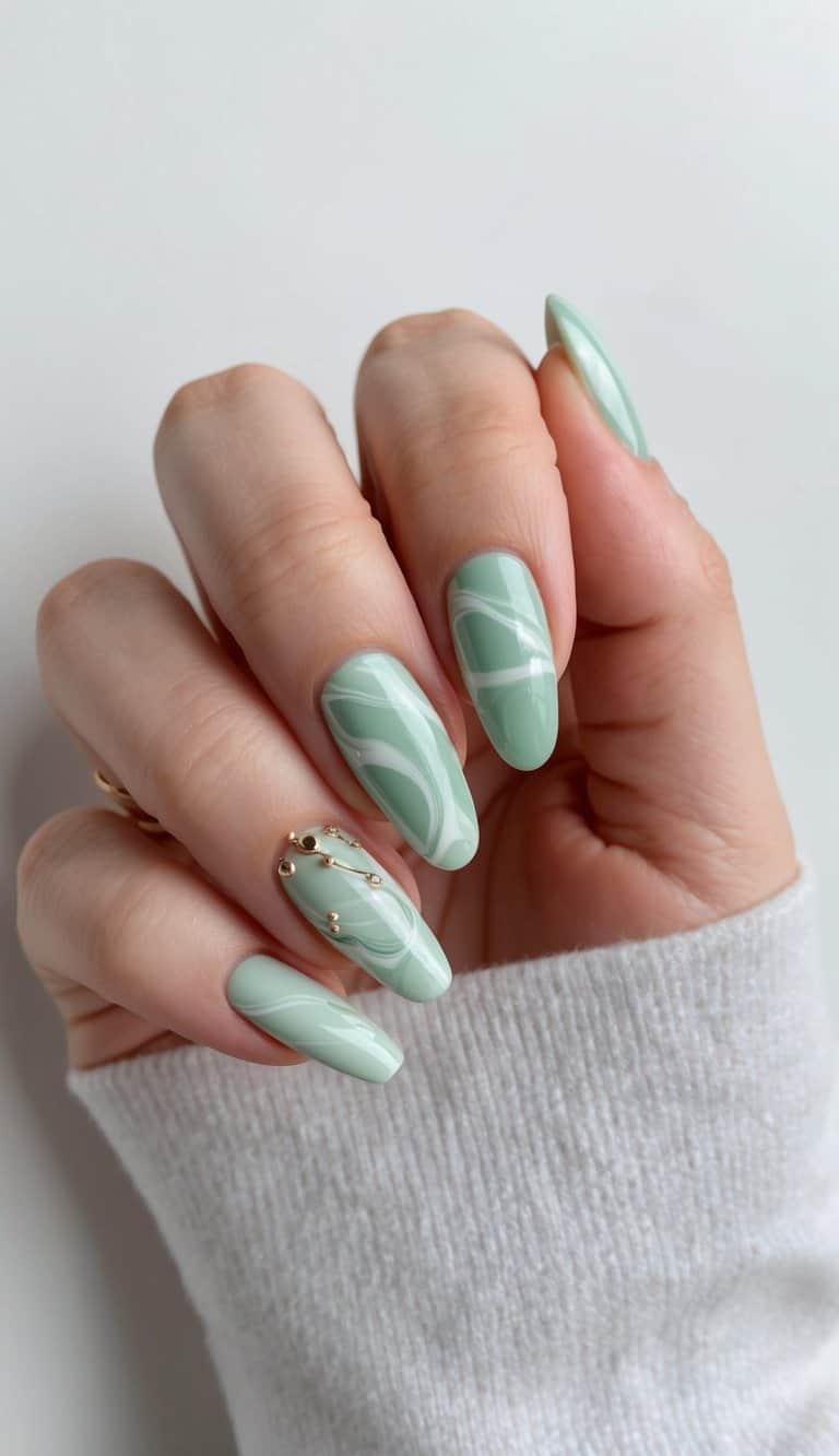 A marble swirl pattern in soft sage green, with delicate nail art designs