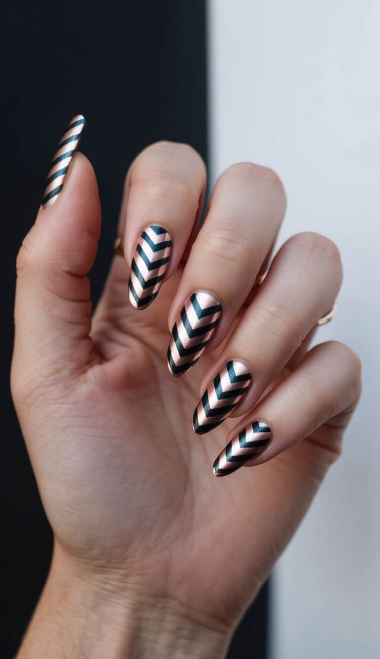 A hand with chevron-striped metallic nails against a dark backdrop