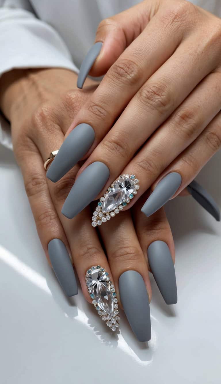 Fifty matte gray nail art designs with crystal embellishments showcased on a sleek surface