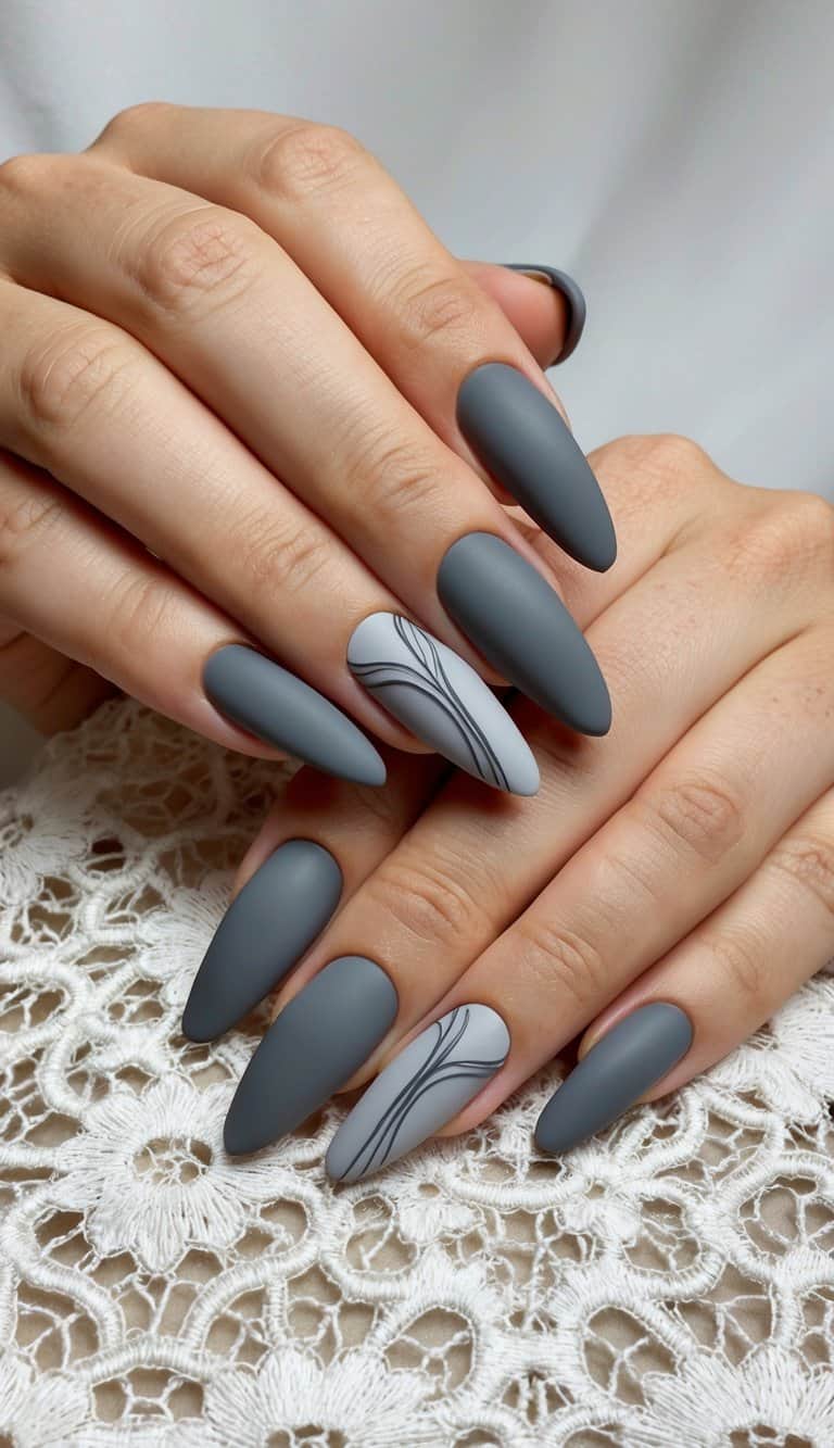 Sleek matte gray nail art designs displayed on an elegant lace background