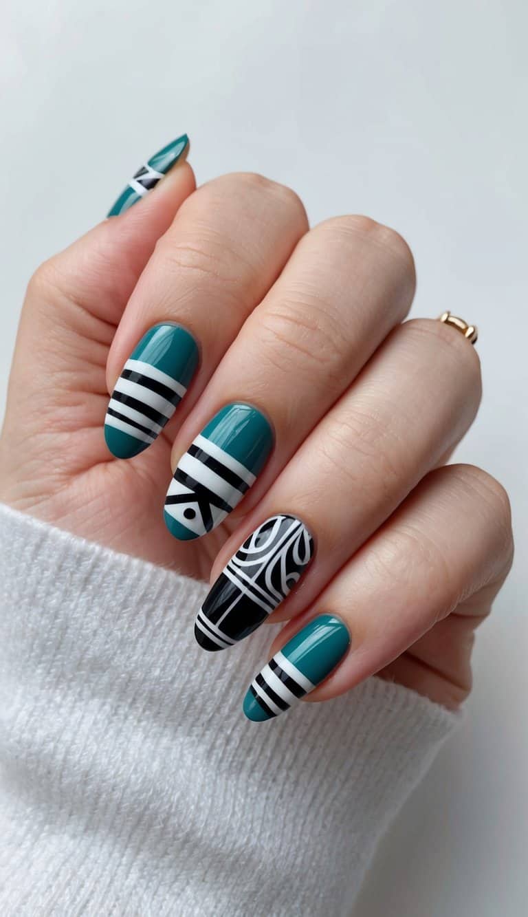 A teal and black modern nail art design with bold patterns and intricate details