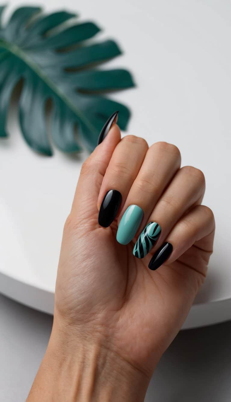 A close-up of black and teal nail art designs on a sleek, modern surface