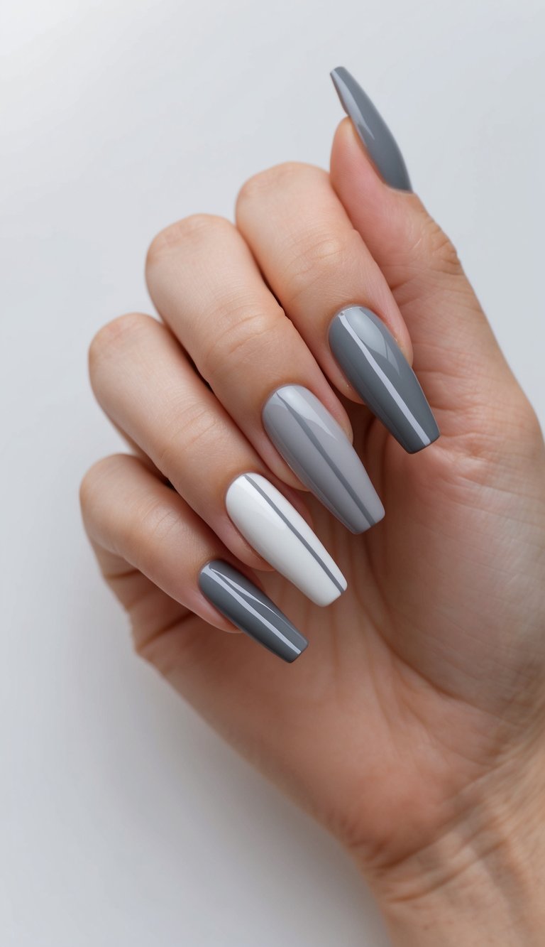 A clean, modern nail design with sleek lines and geometric shapes in shades of gray