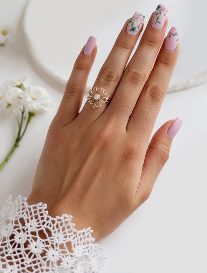 Hand-painted pink roses bring a soft, feminine charm to this pastel manicure