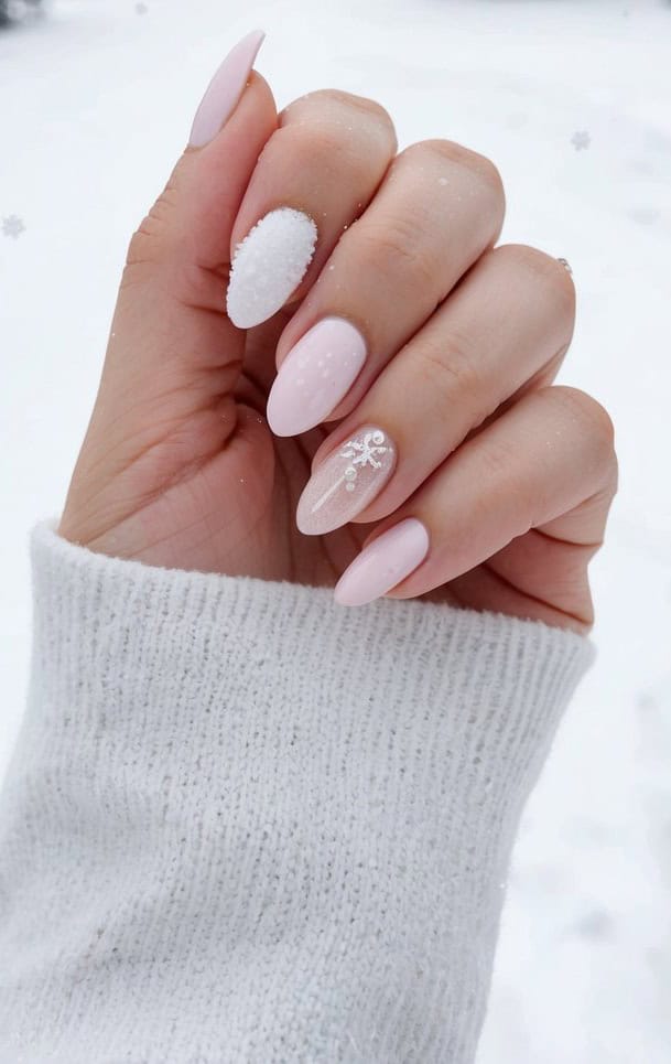Pale pink nails showcase frosted textures, sparkling embellishments, and a dainty snowflake motif