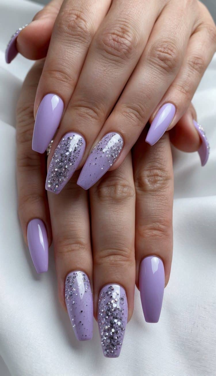 A close-up of lavender nails with silver glitter, shown in a dreamy and elegant display