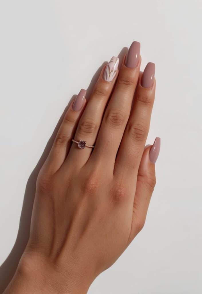 Soft mauve nails with neutral tone designs arranged on a clean, minimalist background
