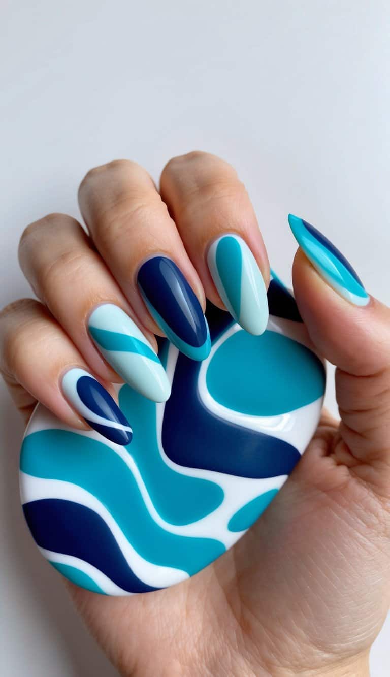 A swirling sea of aquamarine and navy blue abstract shapes, creating a serene and elegant nail art design