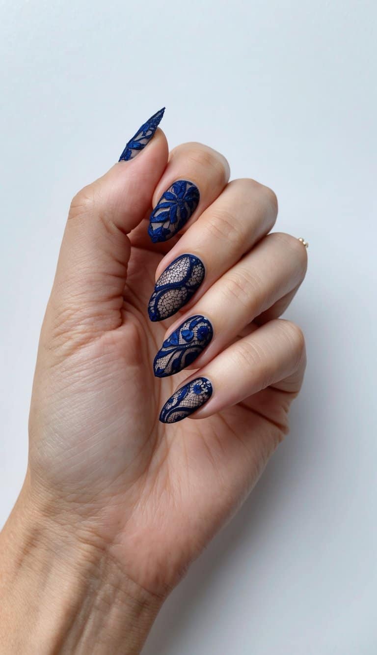 A close-up of navy lace elegance on blue nails, with intricate designs and delicate patterns
