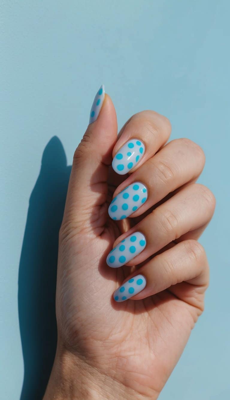 A sky blue polka dot nail art design on a serene blue background