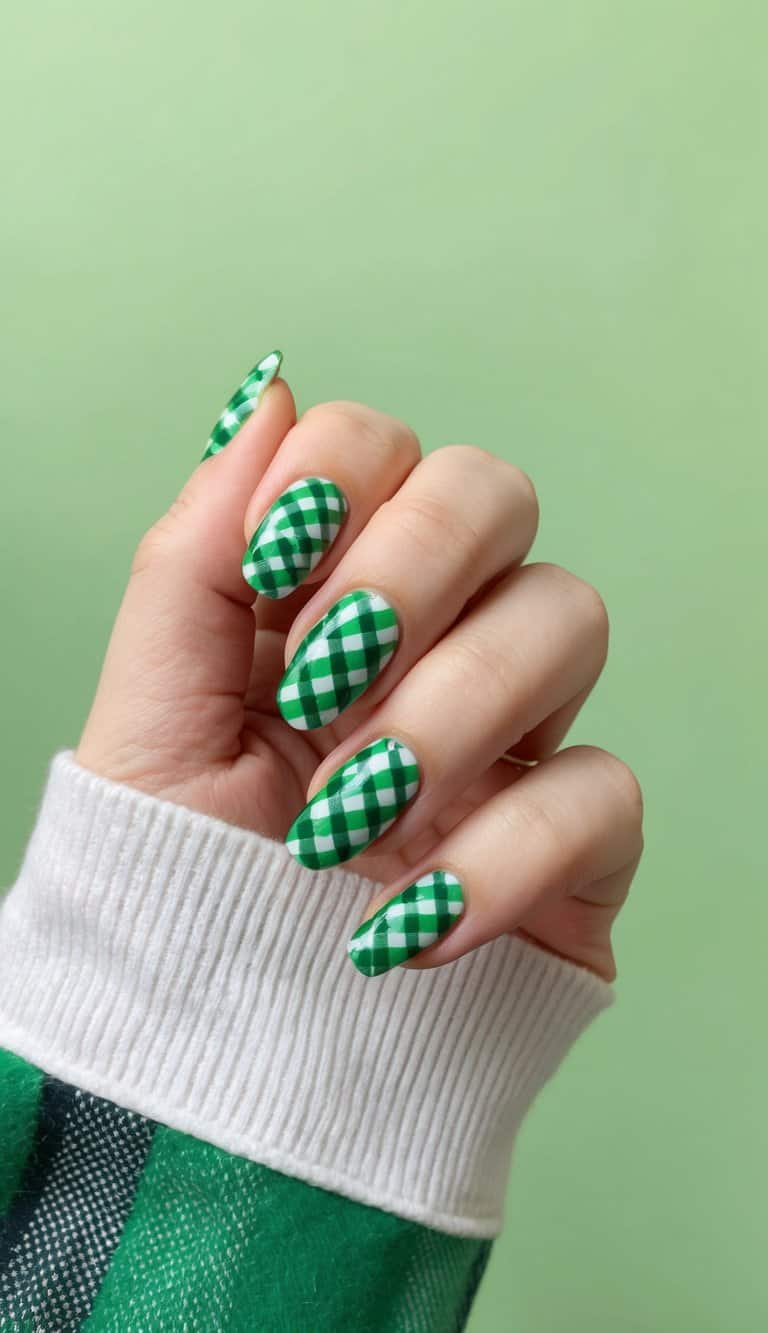 A close-up of green plaid pattern nail art on a refreshing green background
