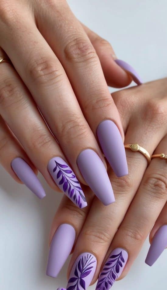 Soft lilac matte nails adorned with stunning purple designs, displayed on a clean, minimalist background