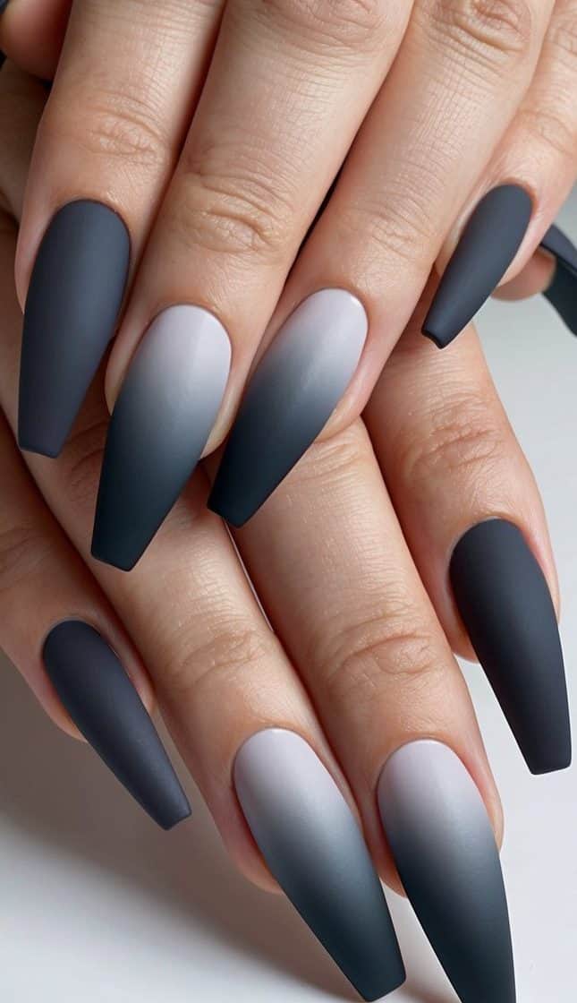 A sleek, elegant nail art design featuring a gradual ombré effect in shades of charcoal gray, with a matte finish