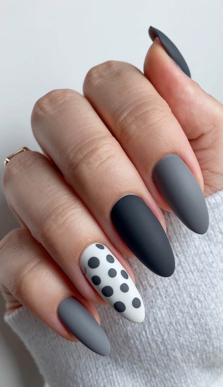 A collection of elegant gray nail art designs, showcasing playful charcoal dots and matte finishes