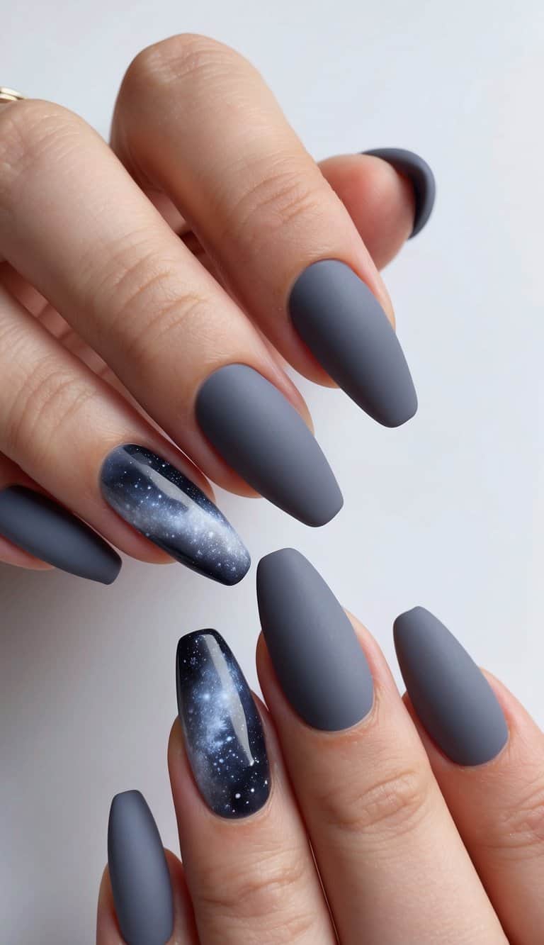 A close-up of elegant gray nail art designs on a matte finish. Shades of gray with a mystic galaxy theme